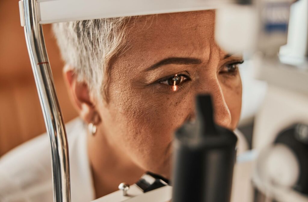 A close-up image of an older adult during an eye exam to diagnose the cause of their new vision symptoms.