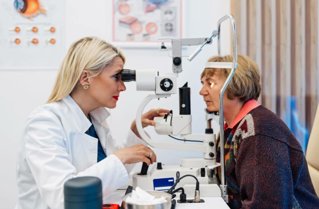 An optometrist evaluates their patient's eye health and symptom severity with a slit lamp exam.