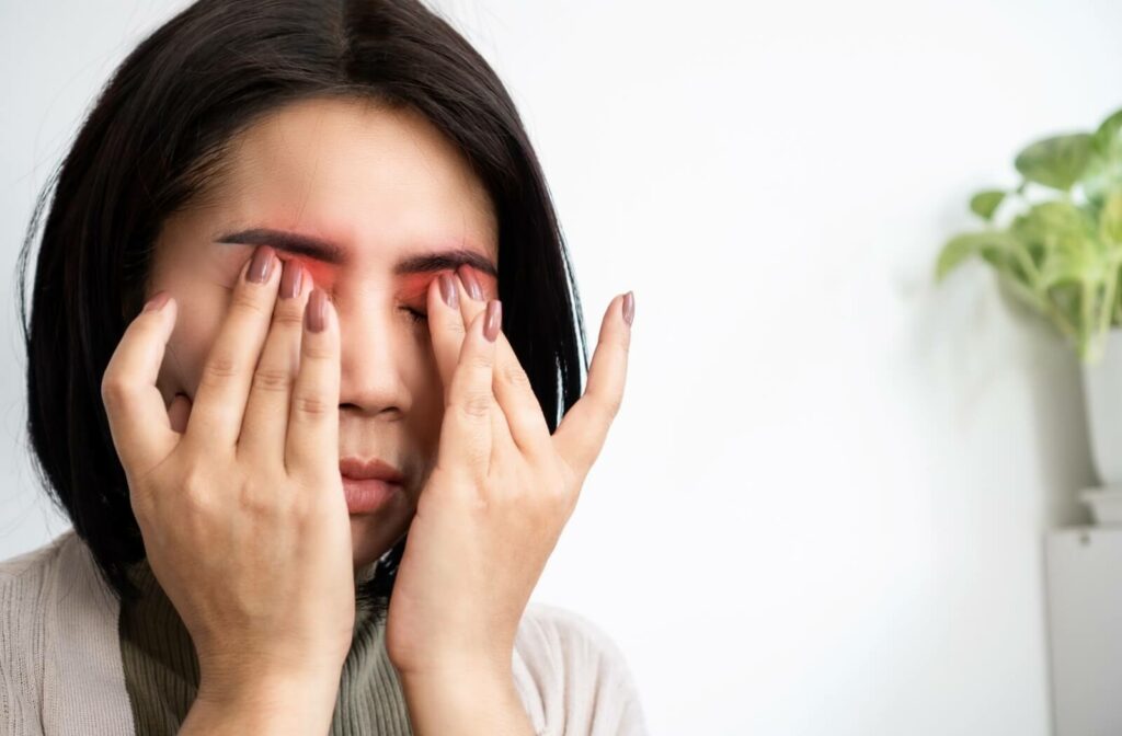 An adult with dry eye rubs their irritated, red eyes to alleviate blurry vision.